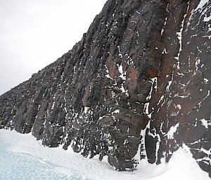 Rocky mountain with snow at the base