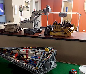 A different view of the LEGO models on the counter top. In the foreground there is another table with a partially completed Lego model of a Star Wars Imperial Star Destroyer