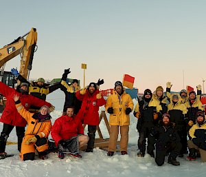A group shot of people smiling on the sea ice