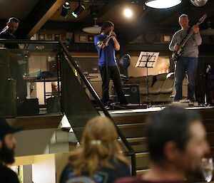 Three band members warming up for the crowd