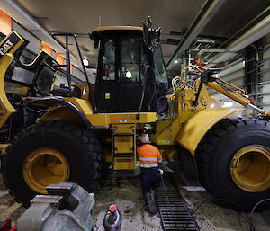 Mechanic working on heavy machinery in workshop