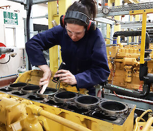 Mechanic checks engine cylinder