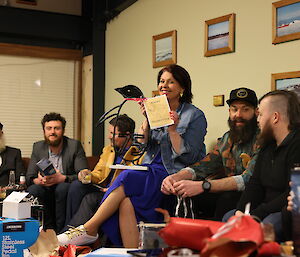 People sitting around on a lounge opening gifts