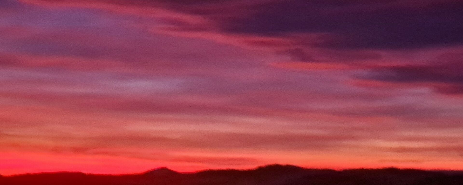 Purple and pink colours in the sky with clouds