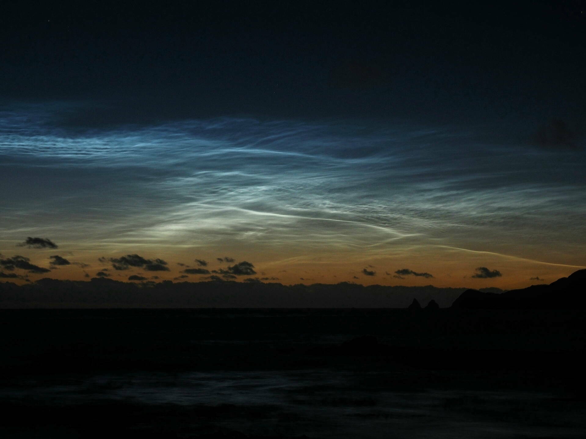 Wispy silver clouds in the upper atmosphere.