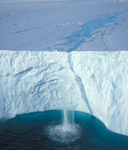 A waterfall cascading over an ice cliff.