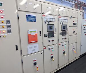 A large white electrical distribution board sits in a room