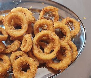 Serving tray filled with fried onion rings