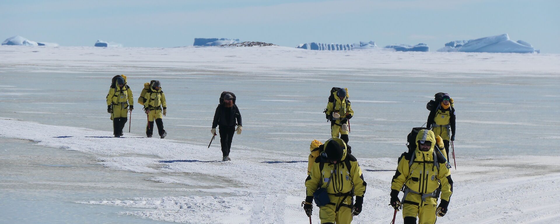A group of expeditioners walking across sea ice