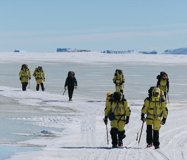 A group of expeditioners walking across sea ice
