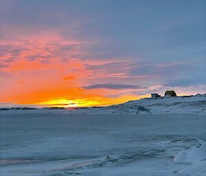 An orange and blue sky over the sea ice