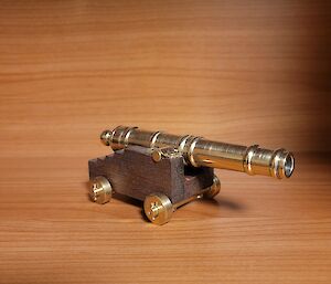 A miniature cannon crafted from wood and brass