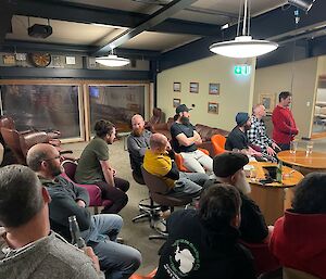 A group of people sitting in bar chairs all facing the same way