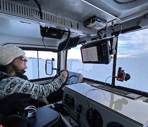 Alana driving a Hägglunds across the Antarctic plateau