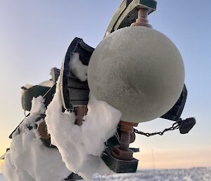 A weather instrument overlooking snow and rocks