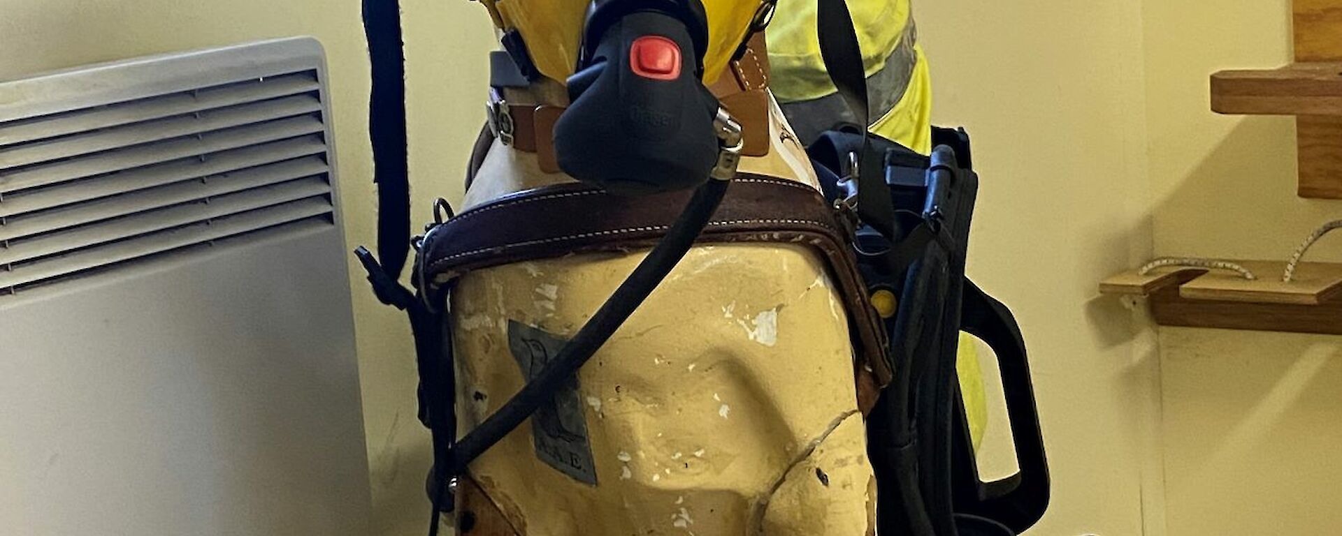 A plastic guide dog is dressed in fire fighting gear