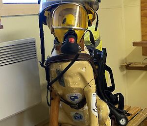 A plastic guide dog is dressed in fire fighting gear