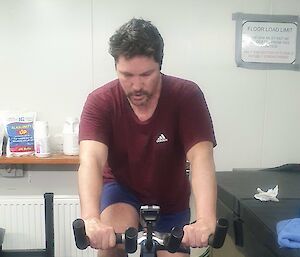 A man riding a gym bike