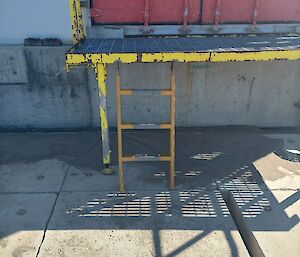 A metal platform with some stairs to gain access to a door