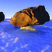 Large rocks appearing balanced on the ice