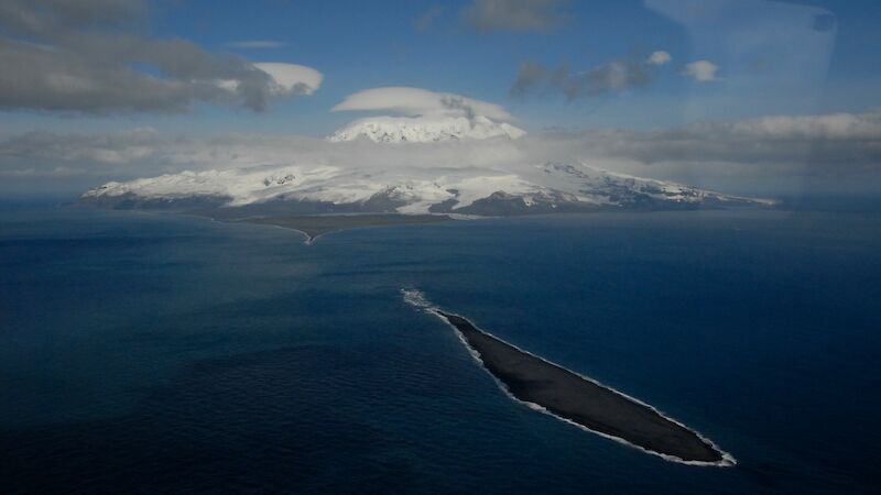 Long narrow deposition bar or beach landform off snowcovered island coast