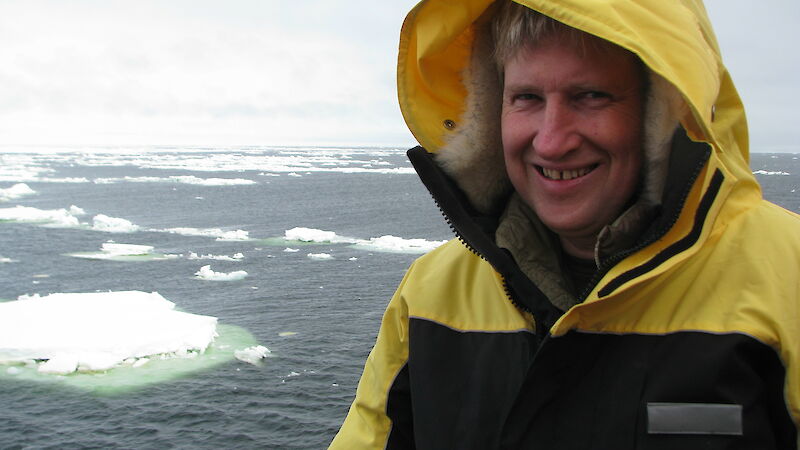 man on ship with icebergs
