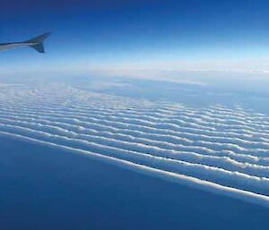 A photo from an aircraft of mountain wave clouds in North America.