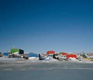 View of Mawson station from the sea ice on a beautiful blue sky day