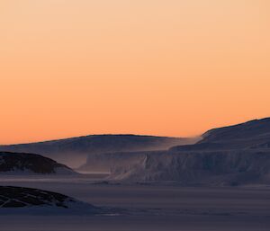 East bay coast in the dawn light with snow blowing off the edge in high winds