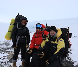 Three people in front of the glacier