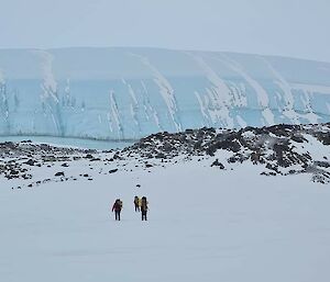 The people looking very small on approach to the glacier