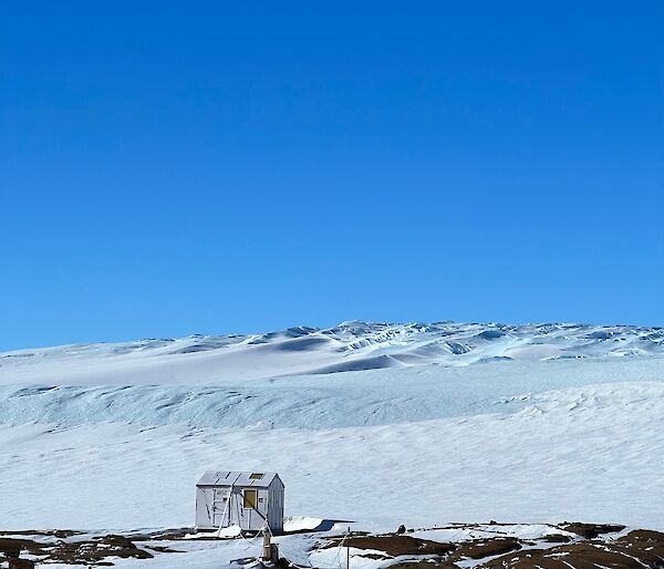 Looking from station across to the ice plateau with blue sky above with no cloud