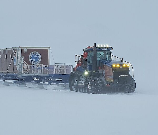 Tractor tows van on sled