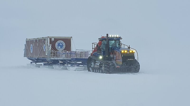 Tractor tows van on sled