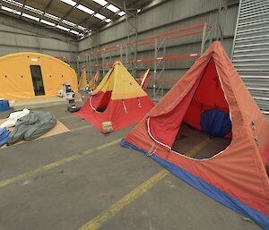 Red and yellow tents in a warehouse