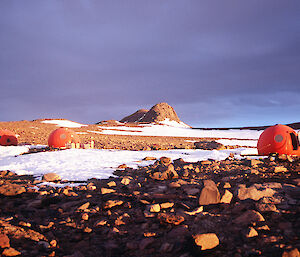 Red huts in a snowy rocky landscape