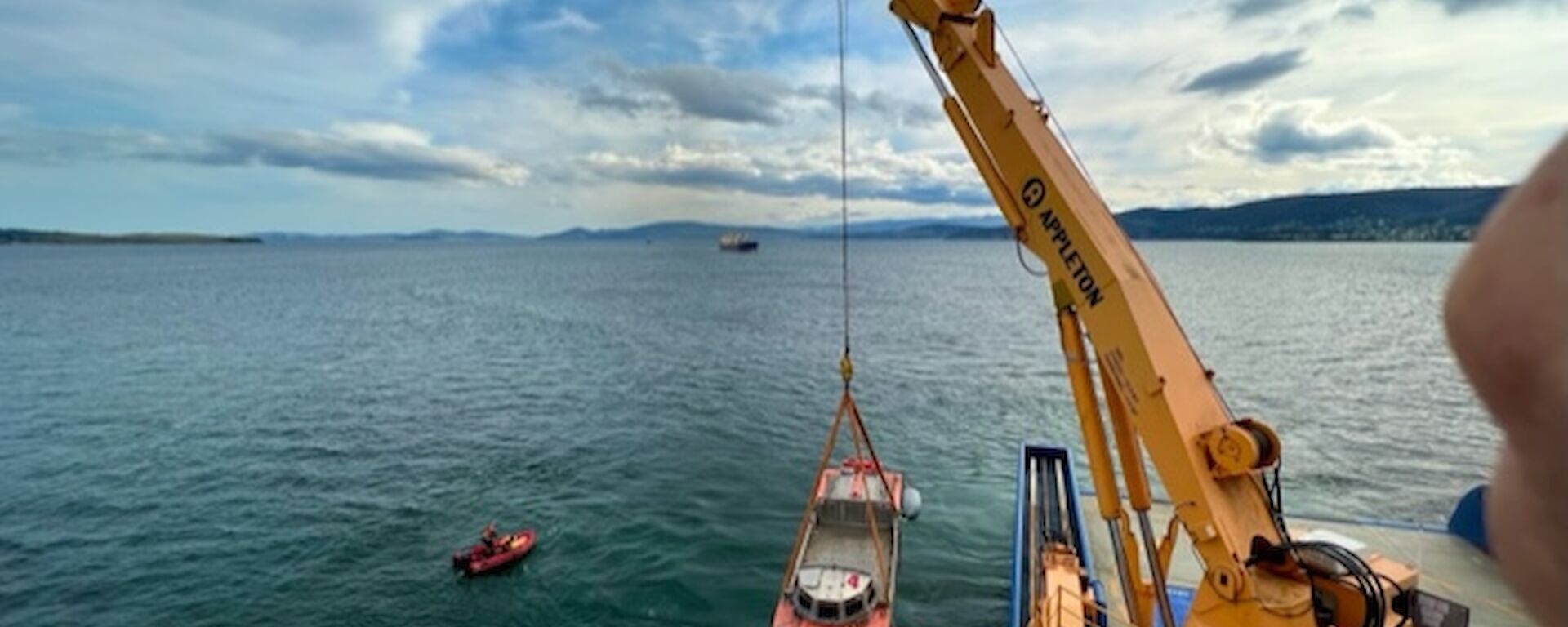 A LARC,(half truck, half boat) being lowered into the sea near Hobart.