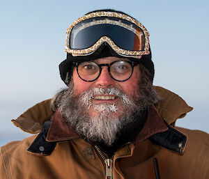 Man wearing cold weather clothing and snow goggles.