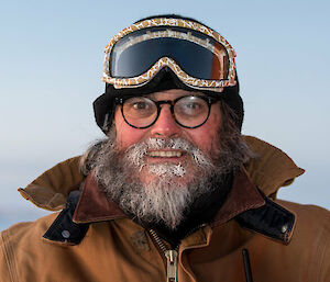 Man wearing cold weather clothing and snow goggles