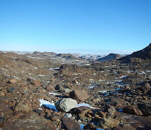 rocks and hills with blue sky in the background