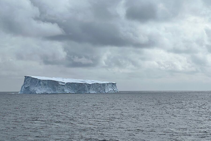 A large tabular iceberg on the horizon