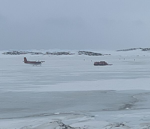 A plane approaching a sea ice runway on a grey day