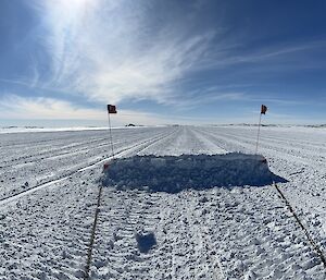 A drag beam on snow under a blue sky