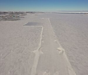 A marked out run way on snow and ice as seen from the air
