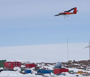 Small plane flying over antarctic station