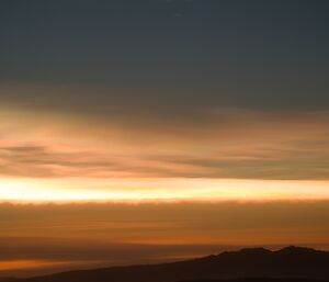 Pearlescent polar stratospheric cloud high above the sunset