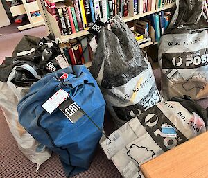 6 mail bags sitting on carpet in the Mawson library