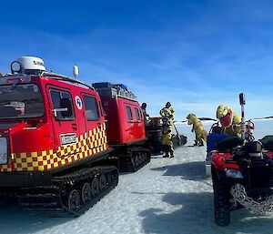 Fueling hagglunds and first responder quad bike with two people dressed in T-Rex suits ready to assist