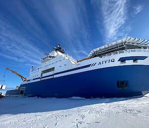 Discharging cargo on to the sea ice from a blue and white ship