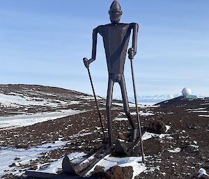 metal figure skiing with blue sky